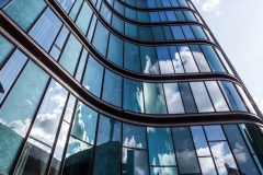 high-rise-building-glass-facade-with-reflection-surrounding-buildings